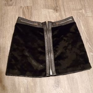 Bebe fuzzy material  with 100%genuine leather accent zip up mini skirt